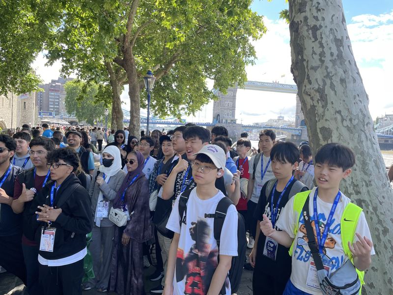 Students from many countries walking along the Thames near Tower Bridge