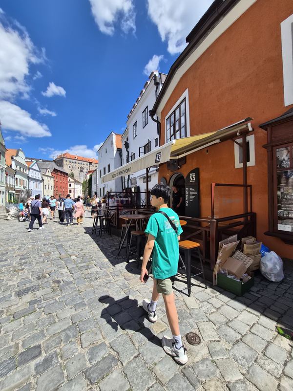 Mark walking down a cobbled street in Český Krumlov